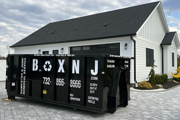 BoxNJ dumpster rental on driveway.