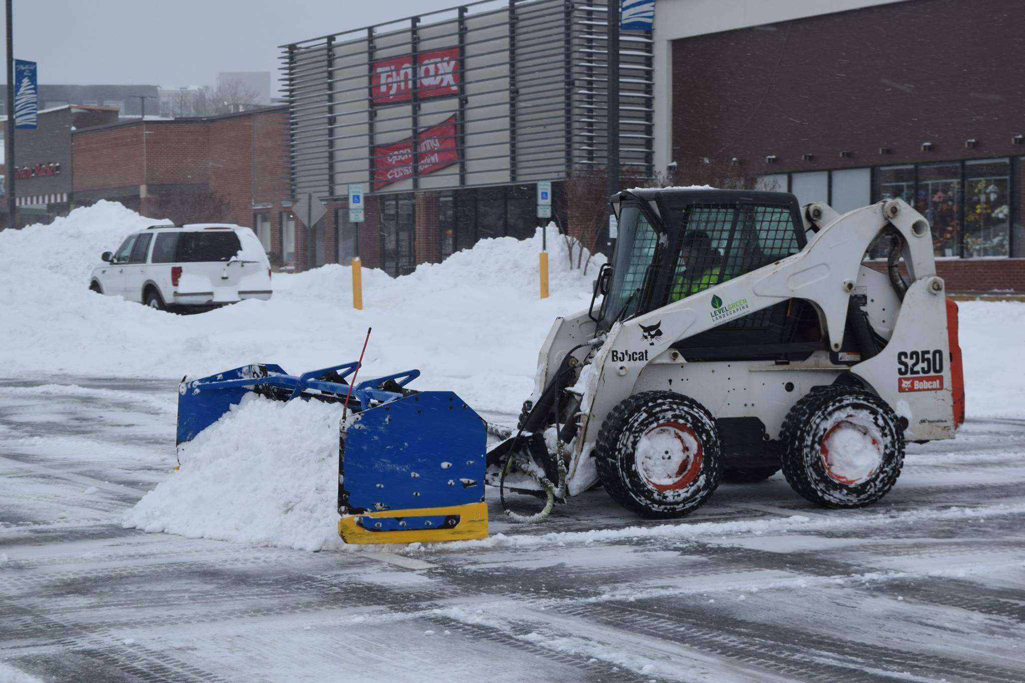 Snow removal in commercial parking lot.